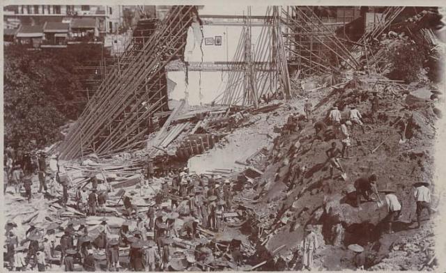 Workers clearing away the debris of the collapsed retaining wall and houses at Po Hing Fong in July 1925