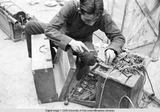 Hong Kong, man unlocking a suitcase