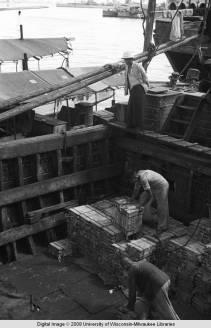 Hong Kong, men on a boat in a harbor