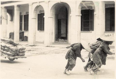 People hauling cart