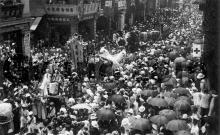 Procession inches along a crowded street