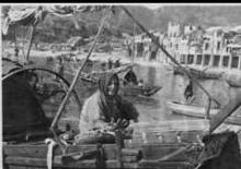 Woman seated in a boat - Stanley, Hong Kong harbor - 1947