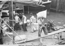 Hong Kong, men working on a pier