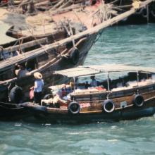 Fishing junk being provisioned from sampan