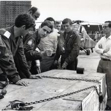 (1) The pilot, Flt Lt Bob Turner, runs through the final briefing points for the lift with his crew