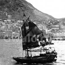 c.1955 Sailing junk in harbour off Sheung Wan