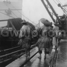 1927 - "Coolies wearing Chinese raincoats"