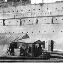 RMS Empress of France getting a fresh coat of paint at the Kowloon Wharves
