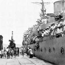 HMCS Prince Robert, next to the pier during the Hong Kong Liberation in August 1945
