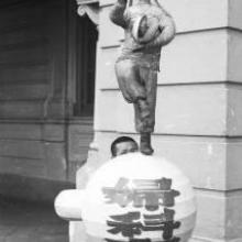 Hong Kong, boy standing in front decorative sculpture