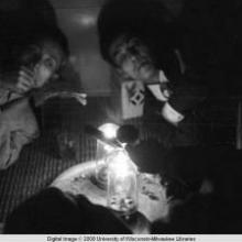 Hong Kong, men smoking in an opium den