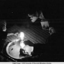 Hong Kong, men smoking in an opium den