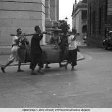 Hong Kong, men carrying a load with a yoke