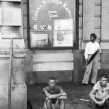 Hong Kong, men sitting on the sidewalk