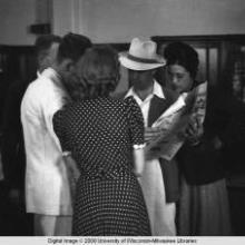 Hong Kong, American evacuees during World War II looking at newspaper