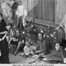 Hong Kong, women with children sitting in street